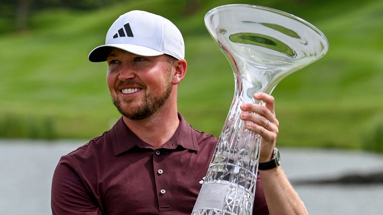 England's Richard Mansell holds the Porsche Singapore Classic trophy after winning his first DP World Tour title (Getty Images)
