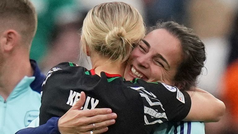 Arsenal's Chloe Kelly and Arsenal coach Renee Slegers hug each other at the end the women's Champions League semifinals, second leg, soccer match between Olympique Lyonnais and Arsenal at OL Stadium in Decines, outside Lyon, France, Sunday, April 27, 2025. (AP Photo/Thibault Camus)