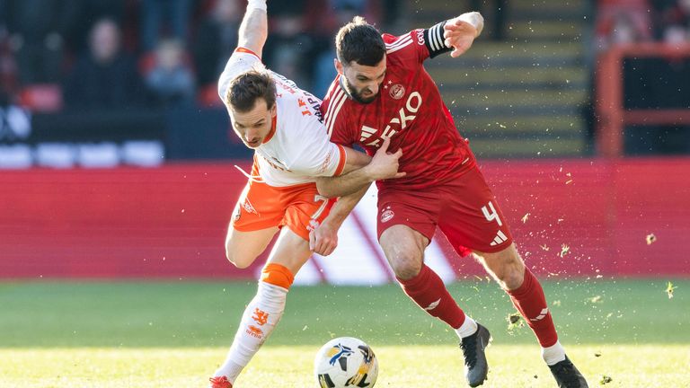 ABERDEEN, SCOTLAND - MARCH 02: Aberdeen's Graeme Shinnie and Dundee United's Kristijan Trapanovski in action during a William Hill Premiership match between Aberdeen and Dundee United at Pittodrie Stadium, on March 02, 2025, in Aberdeen, Scotland.  (Photo by Ross Parker / SNS Group)