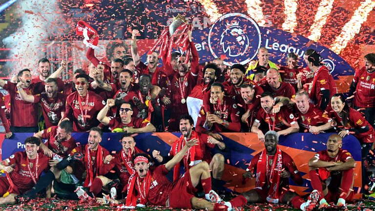Liverpool players celebrate with the Premier League trophy